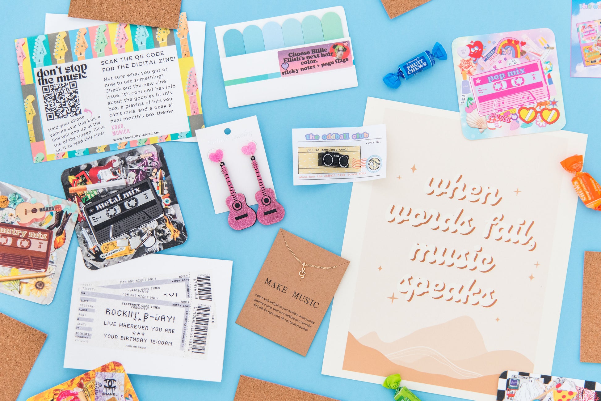 The Oddball Club's Music-themed box with earrings, 'when words fail, music speaks' art print, concert ticket greeting card, and stereo pin.Get your music fix and express your love for music with our unique collection of items.