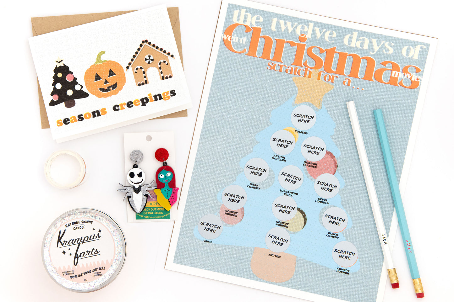 Christmas-themed subscription box with scratch-off movie items art print, pumpkin tree holiday greeting card, Jack and Sally earrings and pencil set, Krampus candle, and decorative washi tape for DIY holiday crafts