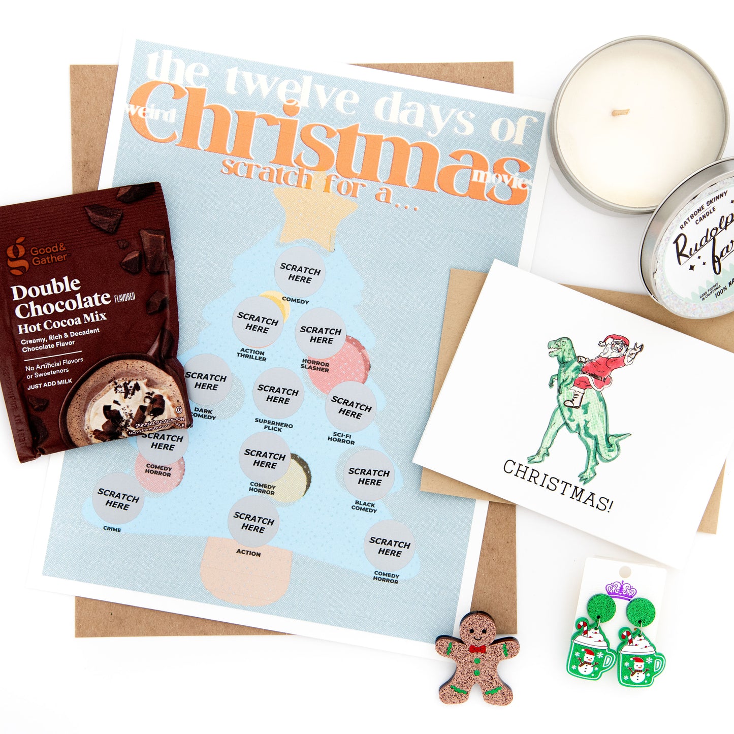 Add some quirky fun to your holiday season with our Weird Christmas Movie-themed subscription box! Scratch off the mystery holiday movie print to reveal your festive movie pick, and enjoy the scent of our Rudolf Farts candle while wearing our festive earrings and gingerbread pin. Don't forget to send holiday greetings with our Christmas card and enjoy a cozy cup of hot cocoa. Order now to experience the perfect blend of holiday cheer and humor.