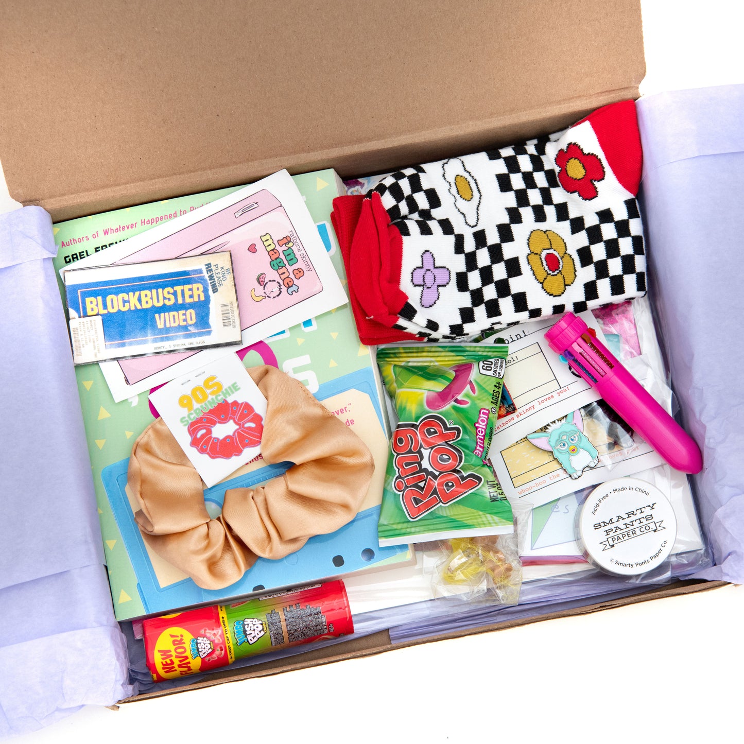 Get your 90s nostalgia fix with The Oddball Club's subscription box! This month's box features a funky pair of socks, colorful scrunchie, adorable furby enamel pin, and iconic blockbuster magnet. Don't miss out on reliving the good old days with this awesome collection of throwback items.