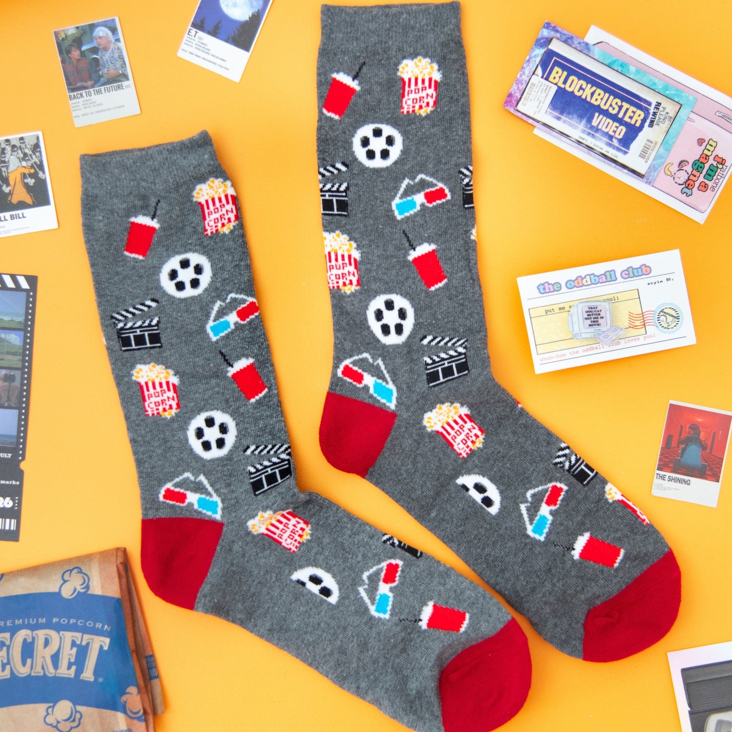 Get ready for movie night with these 3D glasses socks, blockbuster video magnet, TV with VHS acrylic pin, and popcorn-themed accessories.