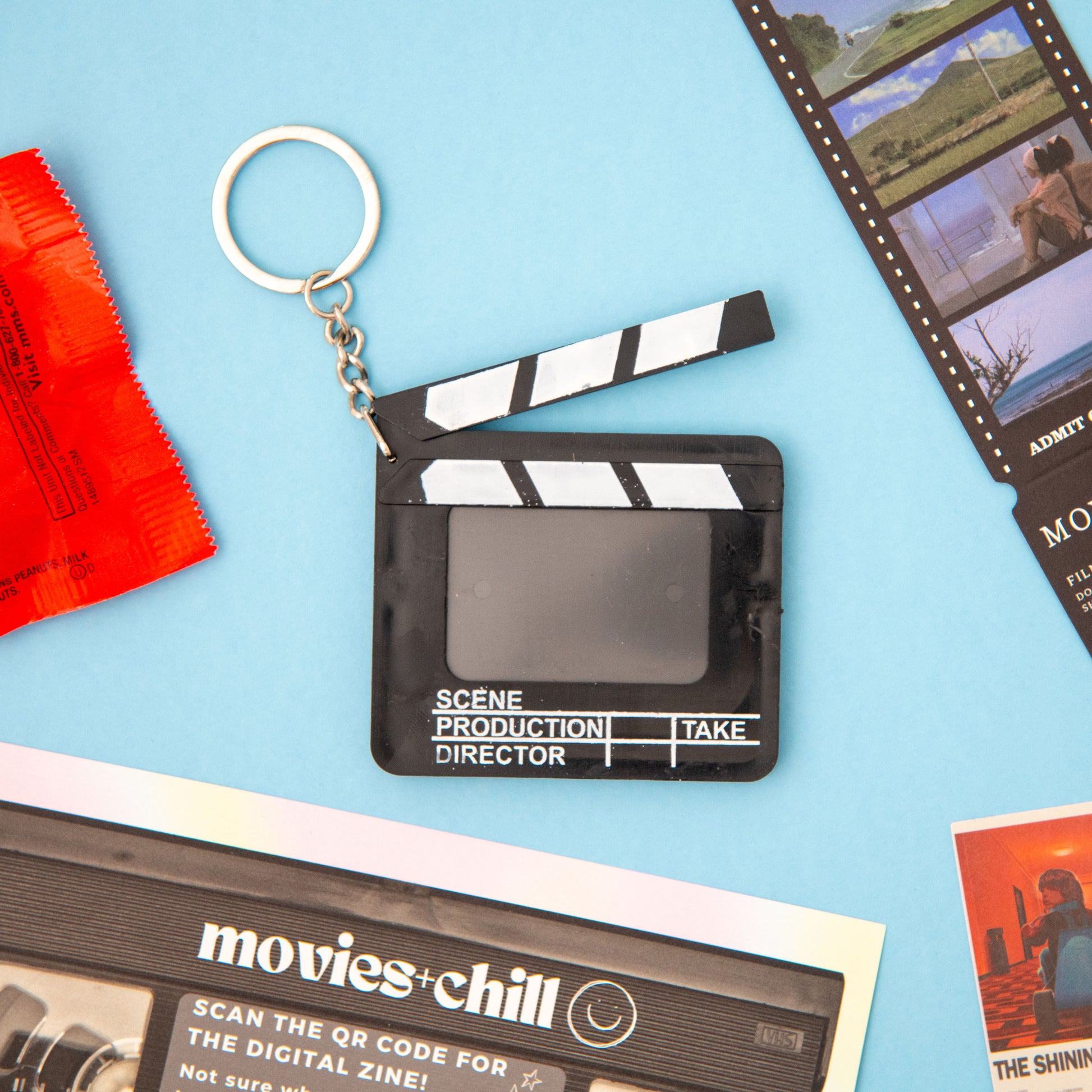 A must-have for movie fans! This directors clapboard keychain is the perfect accessory for film enthusiasts. From our movie-themed subscription box, this keychain is a great addition to your collection. Featuring a black and white design with a clapper and movie details, this keychain is perfect for any movie buff. Get yours today and take the first step to becoming a true movie aficionado!
